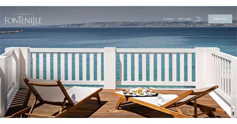 Le Domaines De Fontenille's elegant seafront dining setup, captured in a luxury travel website design highlighting Mediterranean elegance.