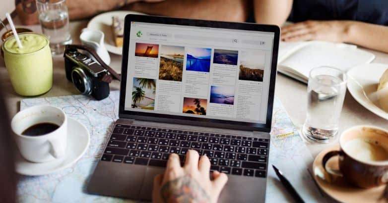 A person browsing a visually appealing travel website on a laptop, showcasing how travel content marketing utilizes websites to inspire and engage travelers.