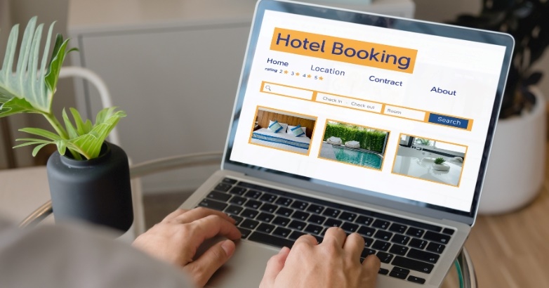 A hotel booking platform displayed on a laptop illustrates how dynamic pricing connects with the booking engine to capture direct reservations in the digital marketing cycle.