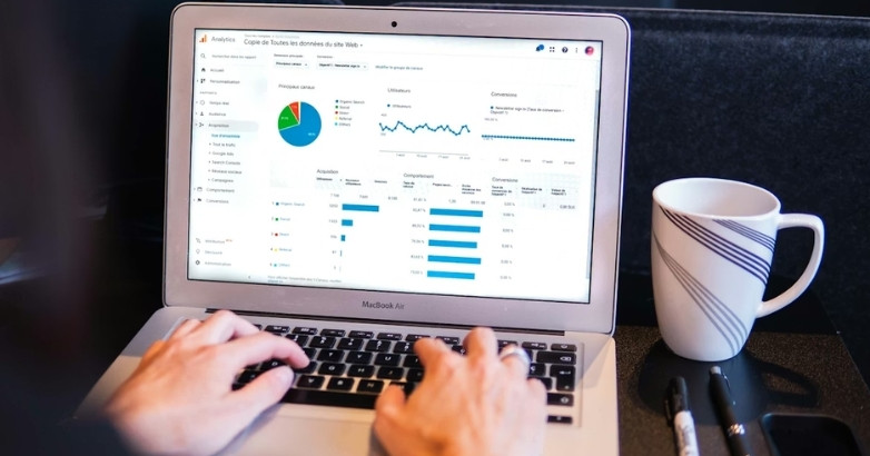 Analyzing hotel advertising performance metrics on a laptop dashboard