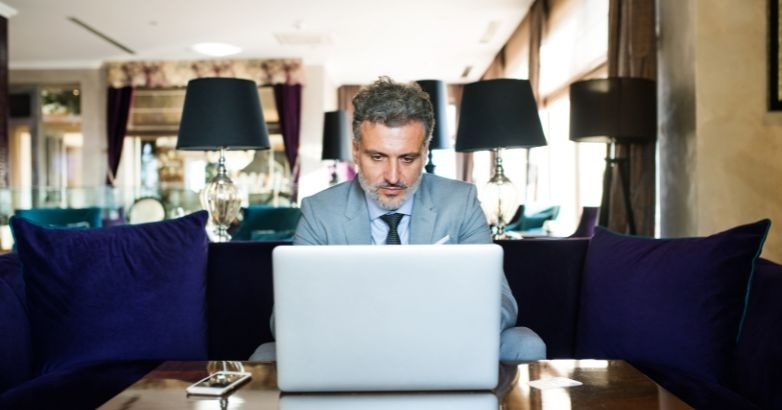 Hotel executive reviewing campaign data, highlighting common luxury hotel advertising mistakes